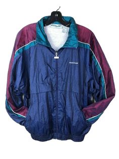 Vtg Dunlop Nylon Jacket Windbreaker. Navy Aqua Maroon. Can be used for Tennis or casual wear. 100% Nylon Shell. 65% Polyester/ 35% Cotton Lining. Zip Front with custom Dunlop Metal Zipper Pull. Elastic Waistband and cuffs. Hand Pockets. Embroidered Dunlop Logo on front Left Chest. Men’s Medium. Chest - 22” Length - 27.5” Vintage Tennis, Sport Jacket, Sports Jacket, Metal Zipper, Rain Jacket, Casual Wear, Tennis, Elastic, Zipper