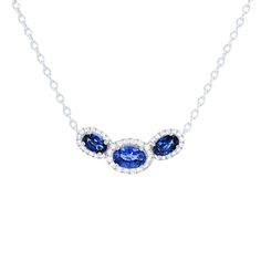 Three oval cut blue sapphires totaling 1.36 carats are framed by 0.21 carats of round brilliant cut diamonds in a halo to create a stunning pendant. Oval Sapphire Necklace With Halo Setting, Oval Sapphire Diamond Necklace, Sapphire Necklace With Oval Halo Setting, Oval Diamond Pendant, Diamonds Direct, True Winter, Oval Diamond, Three Stone, Round Brilliant Cut Diamond