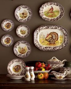 a table topped with plates and bowls filled with turkeys on top of each plate