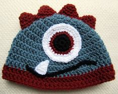 a crocheted hat with an eye on it