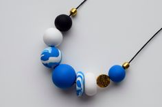 This handmade deep blue beaded necklace is made of unbreakable polymer clay beads. These beads are carefully made by hand, thus each of them can slightly differ in shape and smoothness. Each polymer clay necklace comes in a stylish packaging and makes a perfect gift. This modern necklace would be perfect for everyday wear or special occasion. You can easily dress in your own style with this blue necklace. Add some minimal, clean look to your outfit with this matte necklace. MORE DETAILS - Polyme Handmade Bold Blue Jewelry, Bold Handmade Blue Jewelry, Bold Handmade Polymer Clay Jewelry, Round Beaded Polymer Clay Jewelry, Polymer Clay Jewelry With Large Round Beads, Large Polymer Clay Bead Jewelry, Colorful Beads Polymer Clay Necklaces As Gift, Colorful Beads Polymer Clay Necklaces For Gifts, Colorful Beads Polymer Clay Necklace For Gift