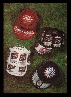 four crocheted baseball caps and mitts on the grass with coca - cola's logo