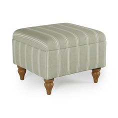 the foot stool is upholstered in ticking fabric and has wooden legs, with a striped