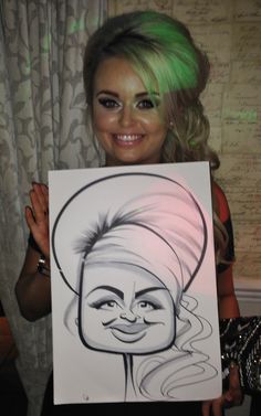 a woman with green hair holding up a drawing