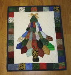 a quilted christmas tree with many different colors on it's sides and bottom