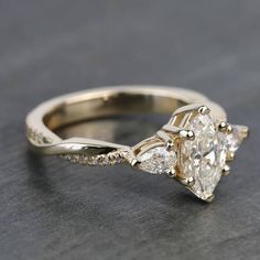 an engagement ring with three pear shaped diamonds