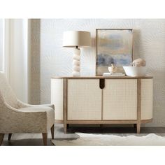 a white chair sitting next to a wooden cabinet