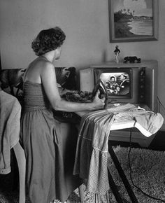 a woman standing in front of an old tv