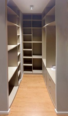 an empty walk in closet with shelves and drawers