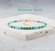 This bracelet showcases the beautiful, vibrant colours of the gemstone Apatite, including aqua and bright neon blues, green and yellow. The gemstones are faceted for brilliant sparkle as your wrist moves, have excellent clarity, and are arranged in a size-graded style from smaller to larger. Accent with your choice of Gold Vermeil or 925 Sterling Silver beads. - Completely natural genuine gemstones measure approx. 2-4mm - Bracelet extends from 6.5-8 inches (custom sizes available on request) - C Apatite Natural Stone Bracelets As Gift, Yellow Gemstones, Vibrant Colours, Sterling Silver Bead, Bracelet Stack, Gemstone Bracelet, Solid 925 Sterling Silver, Aqua Blue, Wire Jewelry