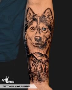 a man with a wolf tattoo on his arm