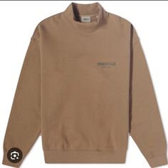 80% Cotton, 20% Viscose, Fleeceback Jersey, Mock Neck, Reflective & Rubber Branding, Ribbed Trims. Fear Of God Essentials Summer Mock Neck Sweat In Harvest. Color: Brown Mock Neck Sweatshirt, Fear Of God Essentials, Sweatshirt Set, Fear Of God, Mens Essentials, Sweaters Crewneck, Mock Neck, Mens Sweatshirts, Men Sweater