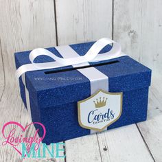 a blue gift box with a white ribbon