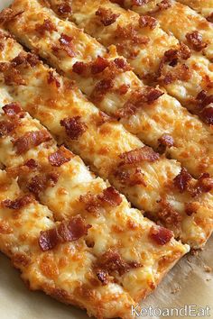 a pizza with cheese and bacon cut into slices