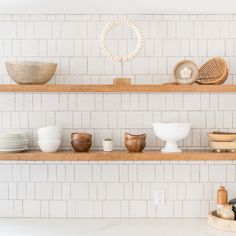 the shelves are filled with dishes and bowls