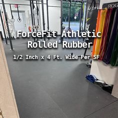 the inside of a crossfit gym with an athletic rolled rubber flooring area