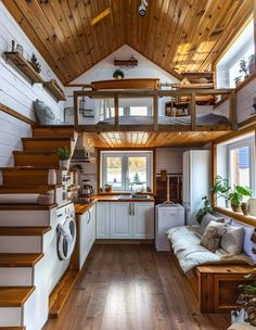 the interior of a tiny house with wood flooring and stairs leading up to an upper level loft