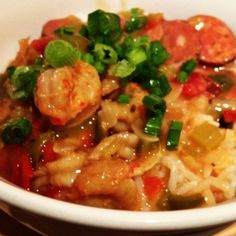 a white bowl filled with rice and vegetables