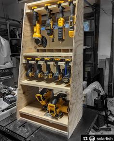 a wooden shelf filled with lots of power tools