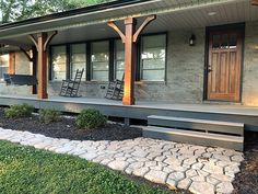 the front porch of a house with stone steps leading up to it