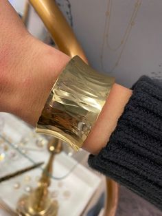 Gold-plated over brass. Adjustable. Luxury Silver Brass Cuff Bracelet, Modern Gold Cuff Bracelet With Wide Band, Modern Gold Wide Band Cuff Bracelet, Polished Brass Bangle Cuff Bracelet, Gold Brass Cuff Bracelet, Polished Brass Cuff Bracelet, Modern Hammered Gold Cuff Bracelet, Elegant Hammered Brass Cuff Bracelet, Elegant Wide Band Metal Cuff Bracelet