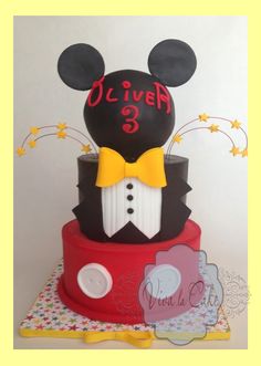 a mickey mouse cake with the number 3 on it's head and bow tie