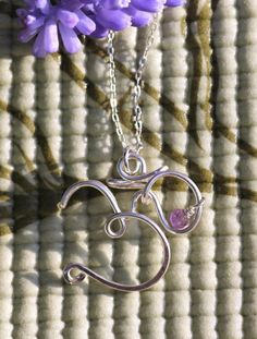 "This sterling silver wire wrapped Om symbol necklace has been designed and handmade with love by me. By wearing this Om necklace, be proud to celebrate who you are and what you stand for. This yoga inspired necklace measures approximately 0.75\" x 1\", and will be made to order. The design will be the same, but no two pendants will look exactly alike. Choose to have it \"plain\", or add a small bead for free (available today: a very tiny blue lapis lazuli, as shown in the first picture). The Om Spiritual Hand-wrapped Silver Necklaces, Spiritual Hand Wrapped Silver Necklace, Wire Wrapped Sterling Silver Jewelry For Meditation, Hand Wrapped Sterling Silver Spiritual Necklace, Symbolic Silver Wire Wrapped Jewelry, Symbolic Wire Wrapped Silver Jewelry, Ohm Symbol, Yoga Om, Om Necklace