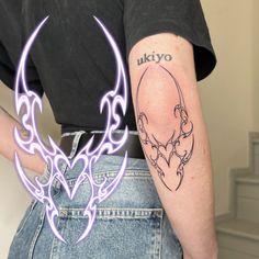 a person with a tattoo on their arm and an image of a demon head in the background