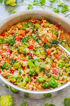 a pot filled with rice, broccoli and other vegetables