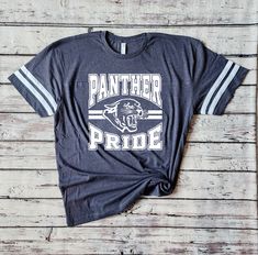 Introducing my Panthers school spirit lightweight jersey LAT tees, the perfect blend of softness, stretchiness, comfort, and cuteness! These tees are designed to elevate your school spirit wear to new levels of style and comfort. Crafted from high-quality lightweight material, these tees offer an exceptional softness that feels gentle against your skin. Embrace the comfort of these shirts, as they provide a cozy and luxurious feel that you'll never want to take off. The stretchy fabric ensures a perfect fit and allows for ease of movement. Whether you're cheering on your team or going about your day, these tees provide unrestricted comfort and flexibility. No more feeling constrained or uncomfortable in your school spirit wear! Shirts are unisex sizing - please see the size chart shown in College School Spirit Shirt With Crew Neck, College Spirit Crew Neck Shirt, College Crew Neck Shirt With School Spirit, School Spirit Sports Shirt In Cotton, Collegiate Pre-shrunk Shirt For College, Cotton School Spirit Shirt For Sports, College Cotton Shirt With Team Name, Pre-shrunk School Spirit Sports Shirt, School Spirit Relaxed Fit Top With Team Name