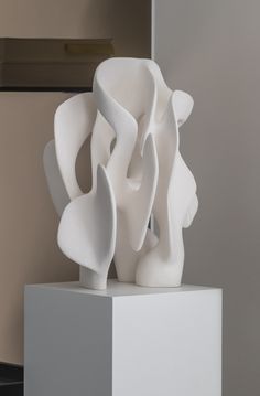 a white sculpture sitting on top of a pedestal