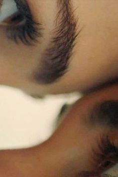 a woman's eye is reflected in the reflection of another person's eye