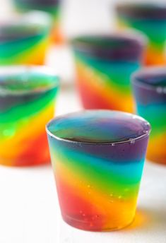 there are many cups that have different colors on them, and one is filled with liquid