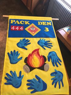 a yellow banner with blue handprints on it