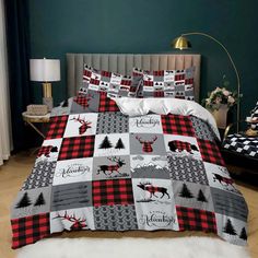 a bed covered in a red and black plaid comforter