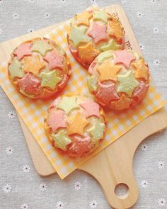 three colorful pastries on a wooden board