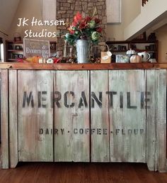 an old wooden cabinet with the words mercantile painted on it's side