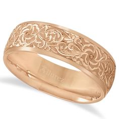 an 18k rose gold wedding ring with filigrees on the outside and inside