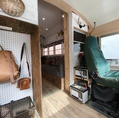 the interior of a camper with its bed pulled up to it's side