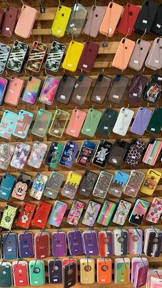 there are many cell phones on display in the store, all different colors and sizes