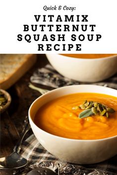 two white bowls filled with carrot soup and topped with pumpkin seeds, on top of a checkered table cloth