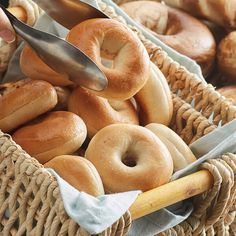 a basket filled with bagels and doughnuts next to a pair of scissors