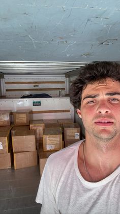 a man is taking a selfie in front of boxes