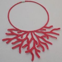 a red necklace with corals on it