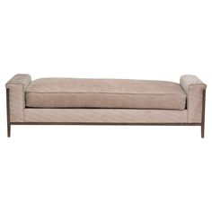 a beige couch with wooden legs on a white background