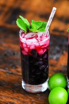 purple cocktail in tall glass with crushed ice. White straw, mint sprig. Limes next to glass. Non Alcoholic Mojito, Cranberry Mocktail, Pineapple Juice Recipes, Kombucha Flavors, Alcohol Free Cocktails, Blueberry Mojito