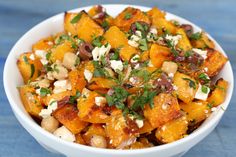 a white bowl filled with lots of food