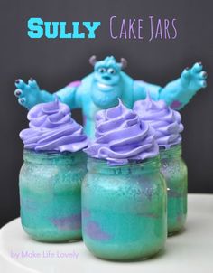 two jars filled with blue and purple frosted cake in front of the words sully cake jars