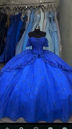 a blue ball gown is on display in a store