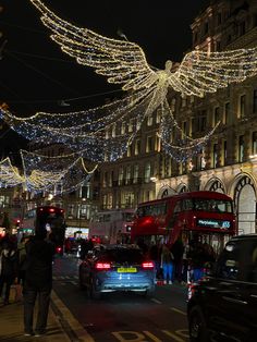 a busy city street at night with christmas lights